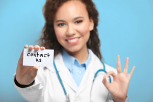 medical-person-holding-contact-us-sign